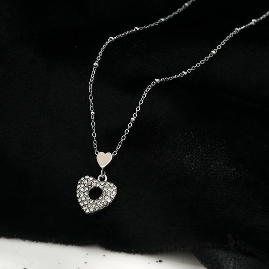 ETERNAL : Collier pendentif double cœur serti de zircones pavées